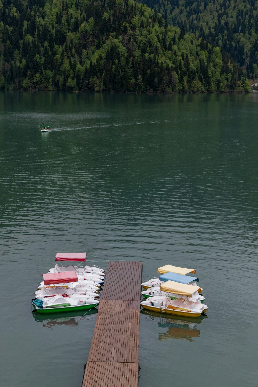 a group of boats floating on top of a lake