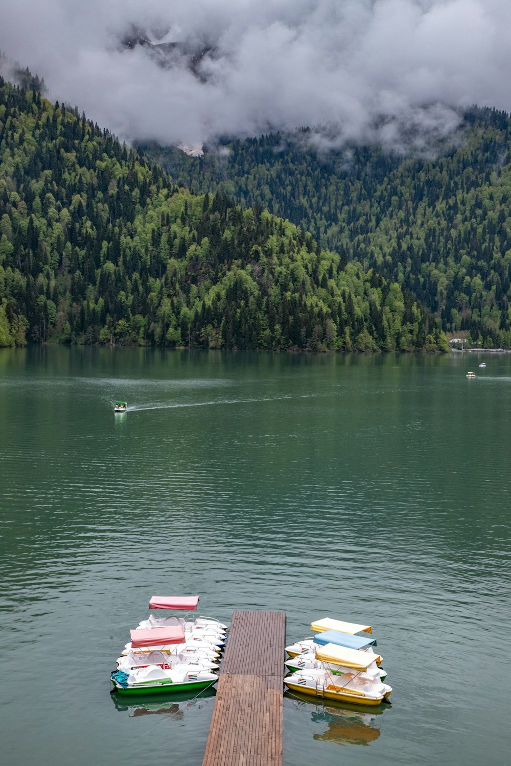 a dock on a lake with boats in the water