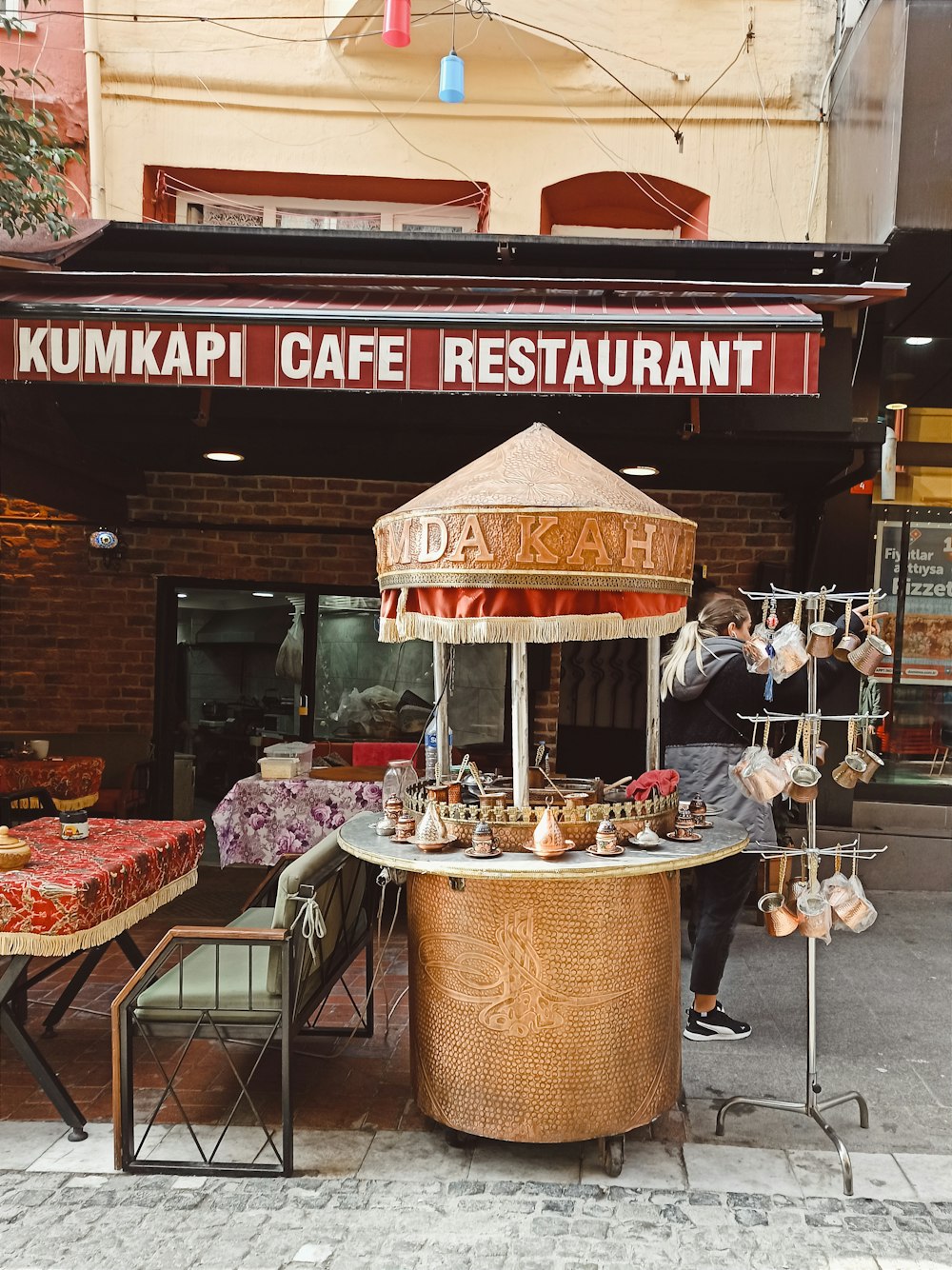 a man standing in front of a food stand