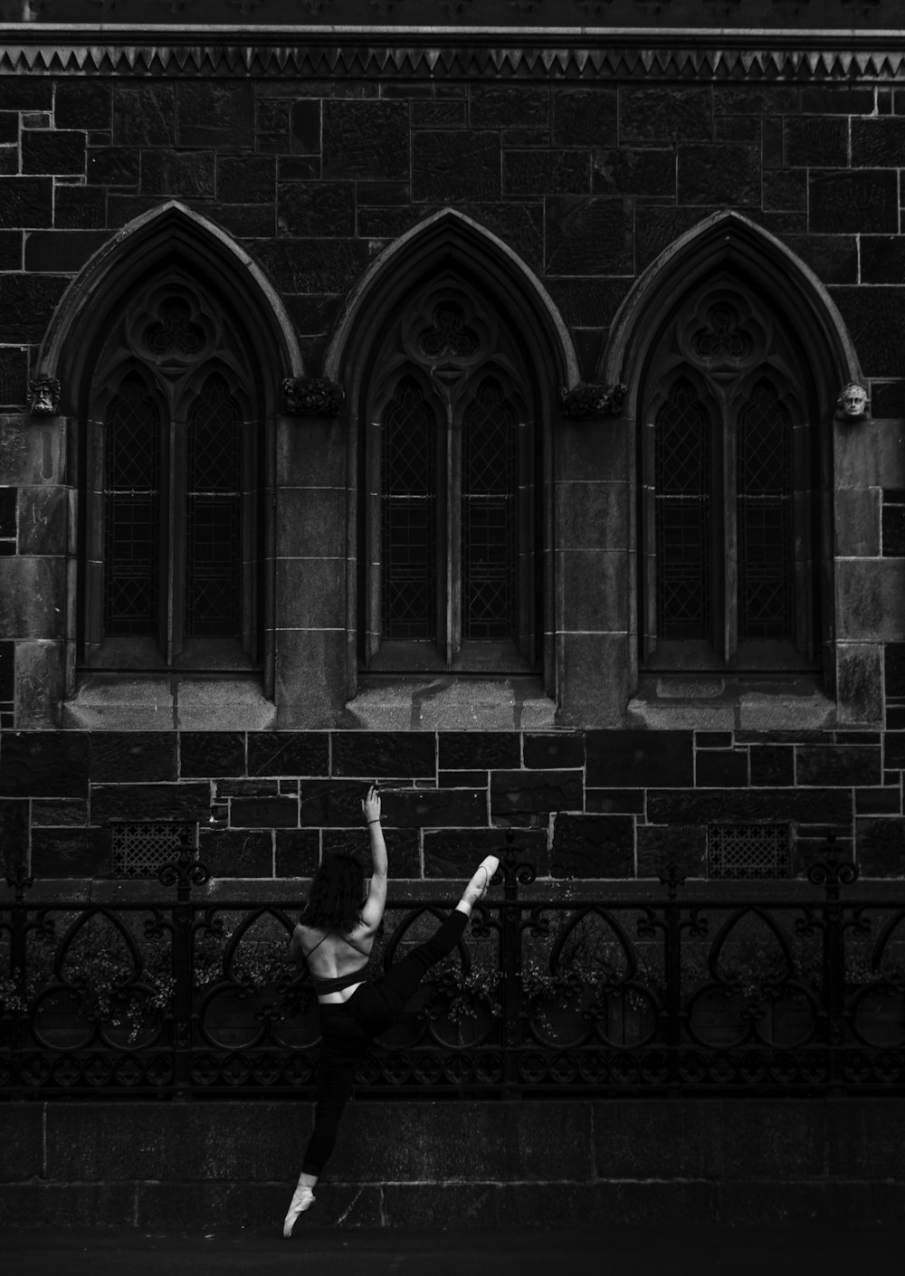 a person jumping in the air in front of a building