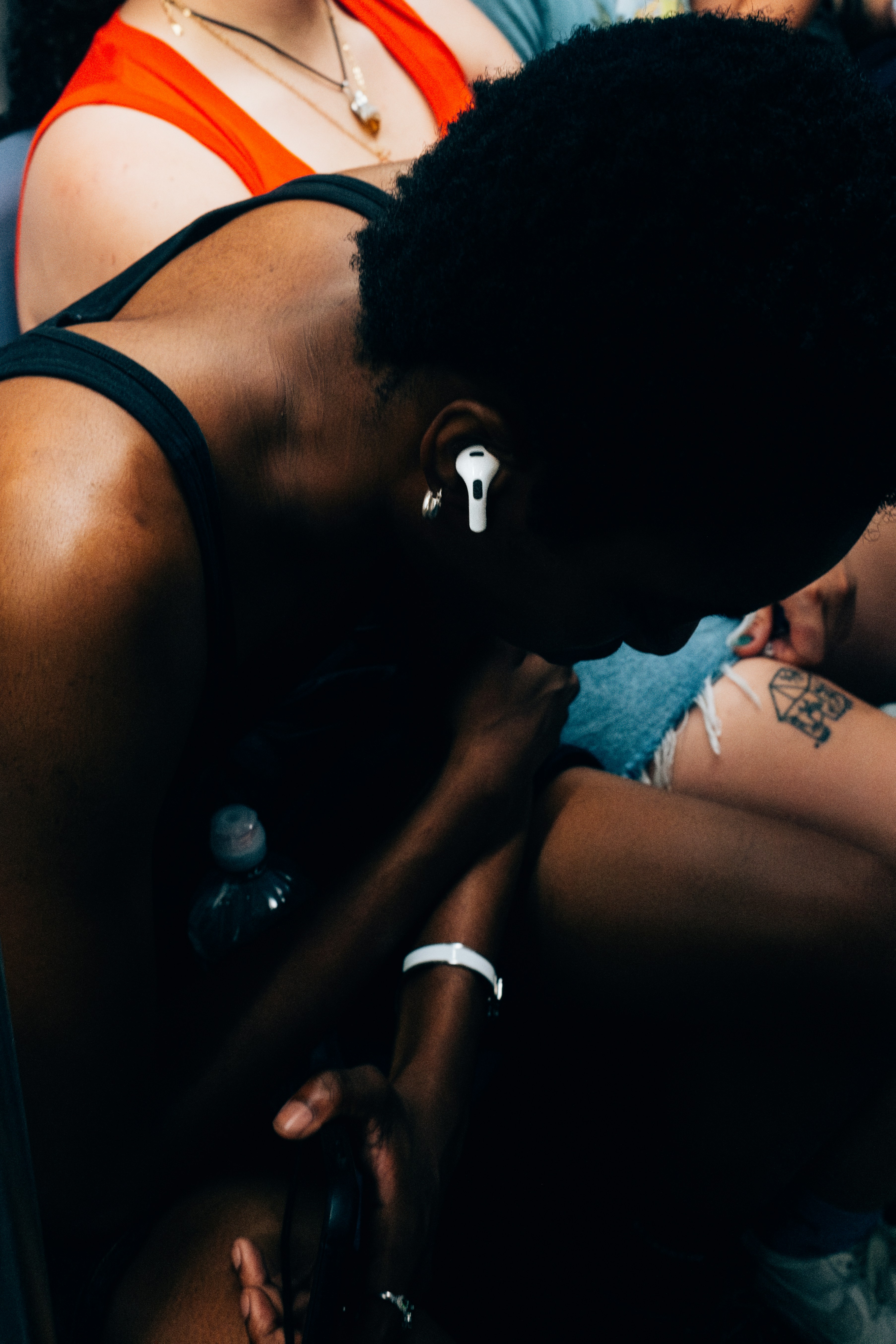 a woman with piercings on her ear sitting on a bed