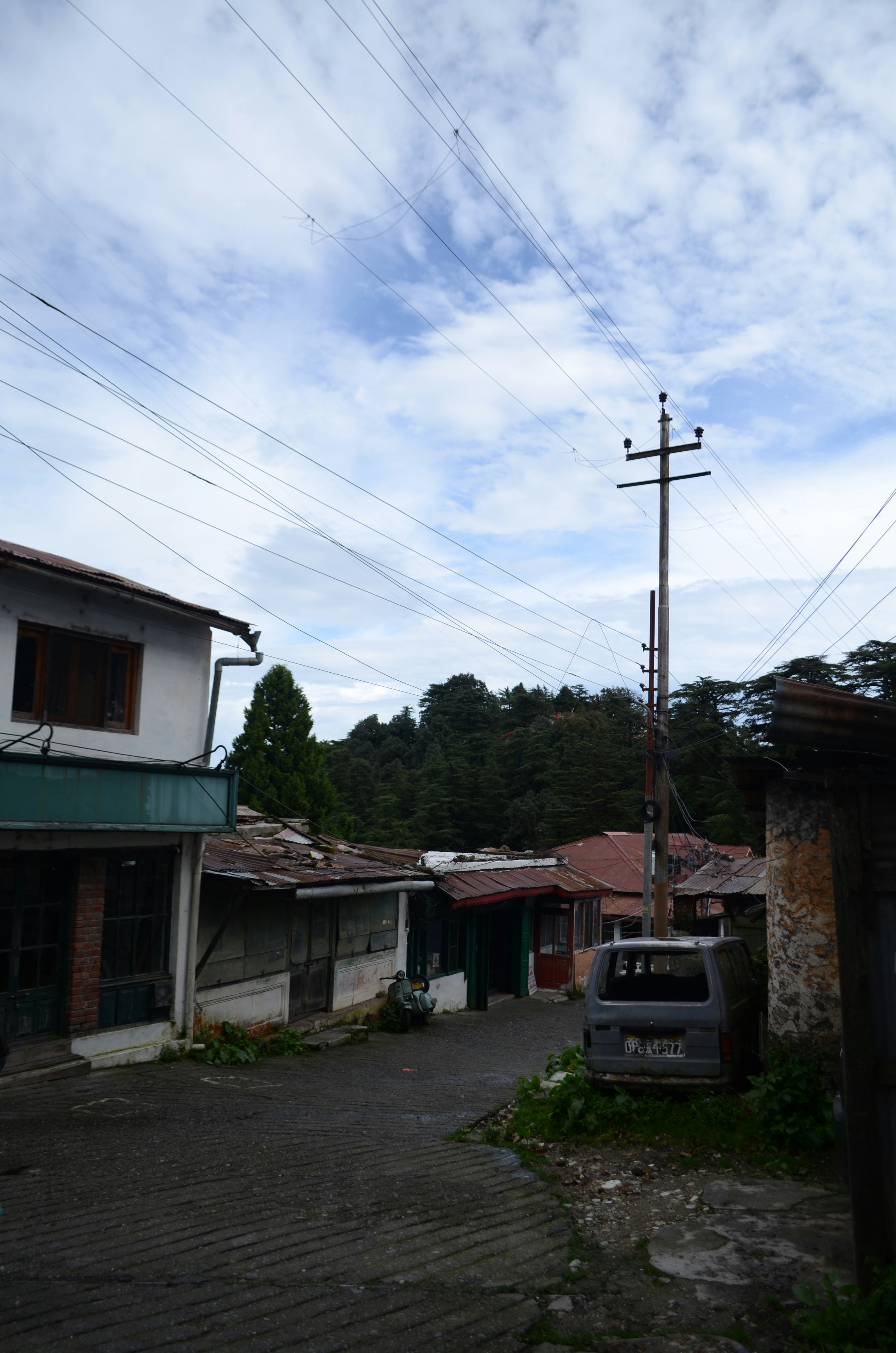 a truck parked in front of a building with power lines above it