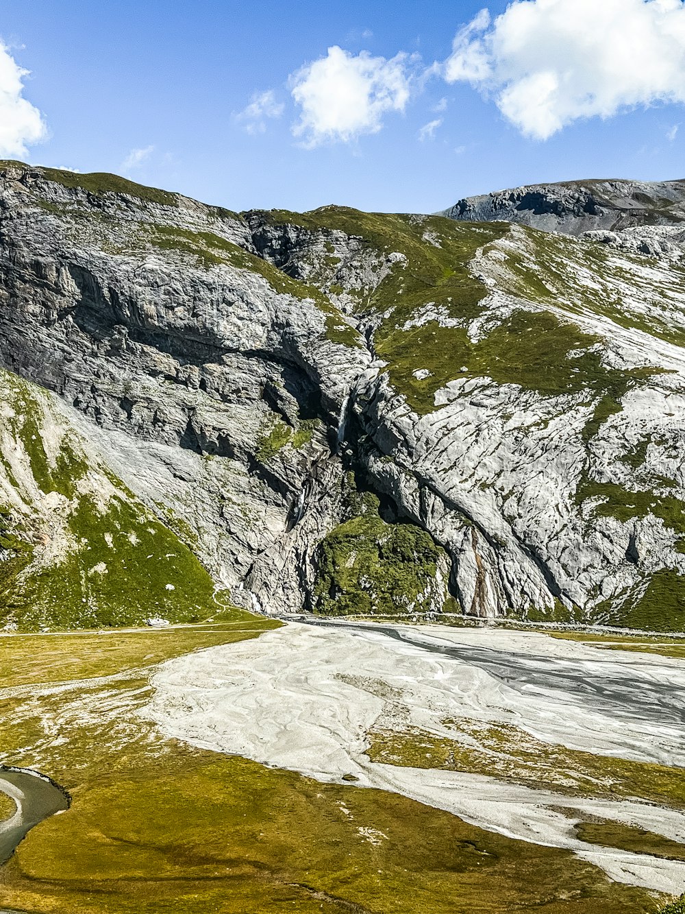 a scenic view of a winding road in the mountains