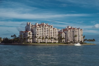 a large white building sitting on top of a body of water