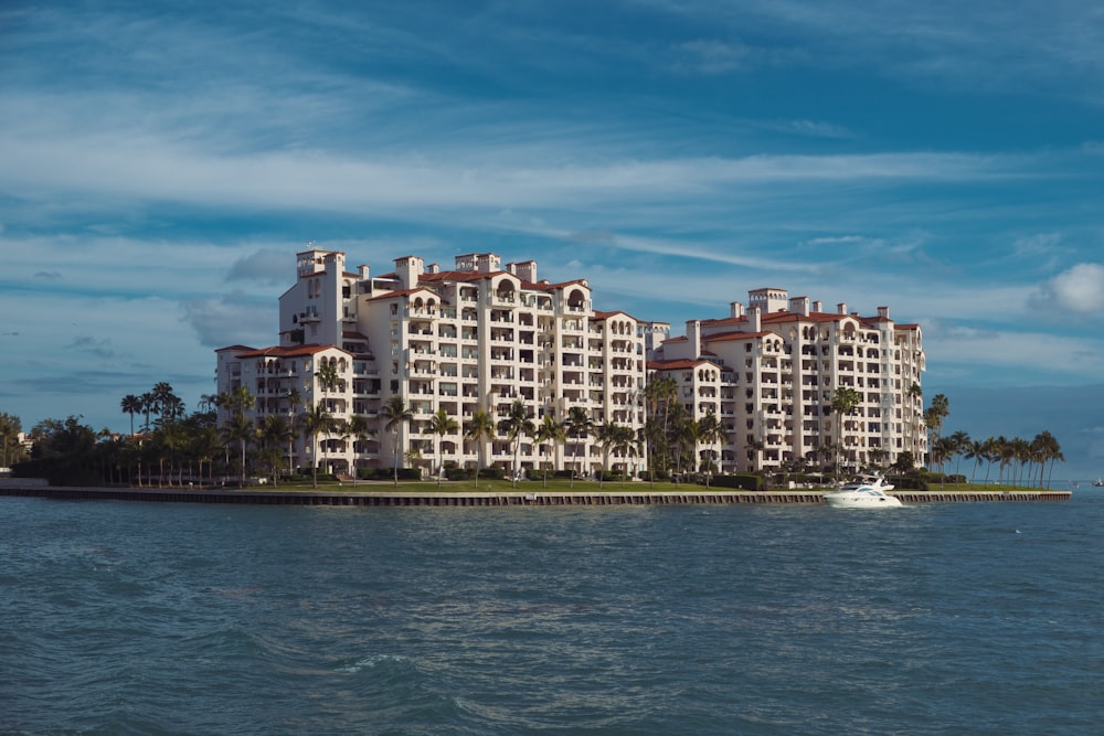 a large white building sitting on top of a body of water