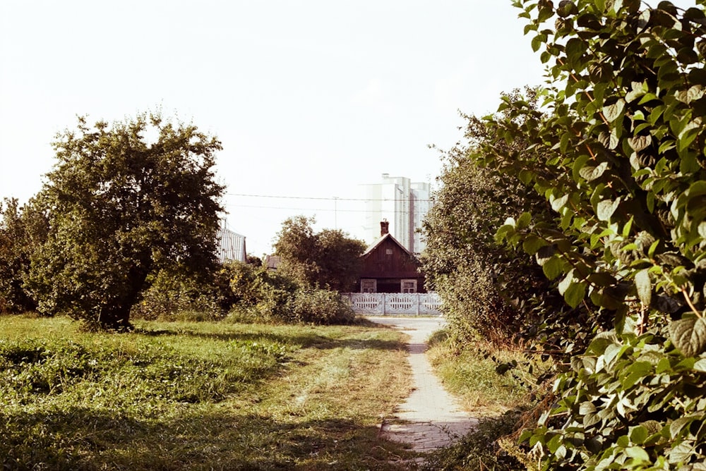 a dirt road with a building in the background