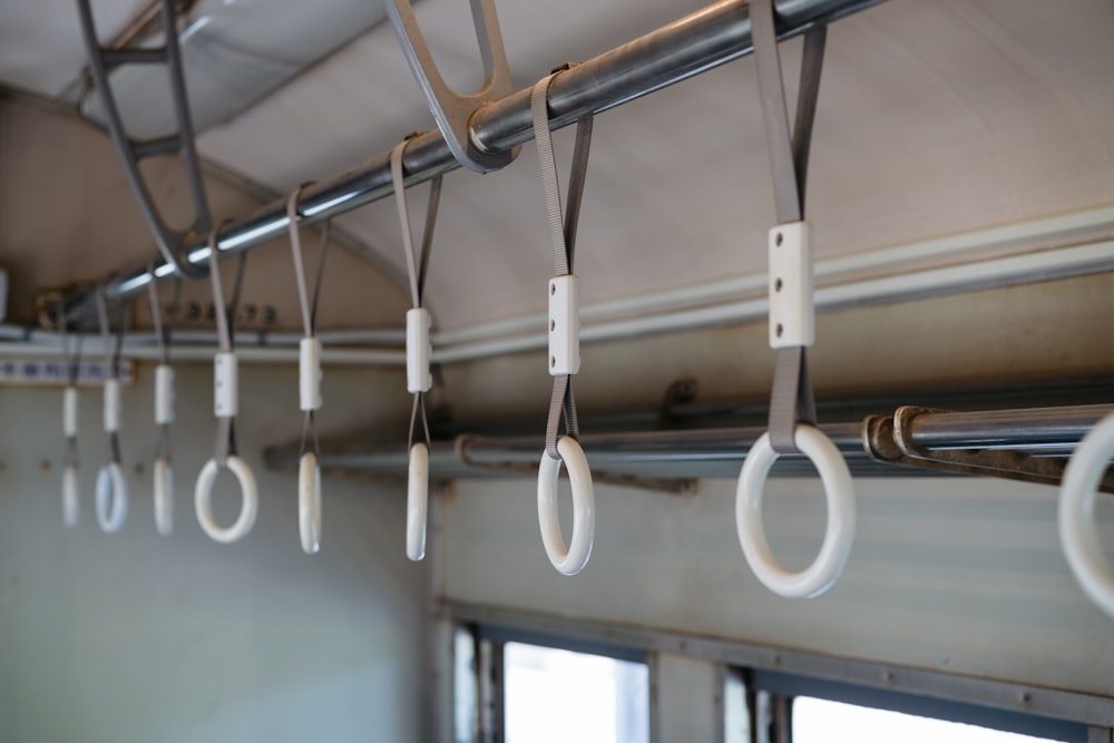 a row of white handles hanging from a ceiling