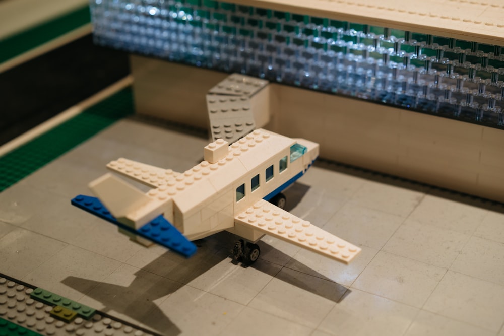 a toy airplane sitting on top of a tiled floor