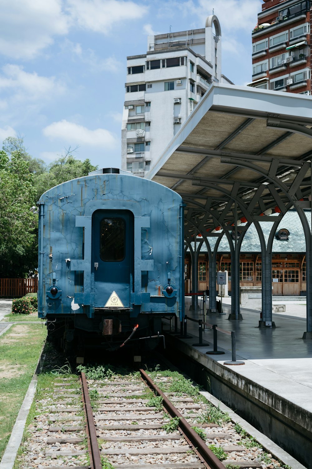 a blue train parked at a train station