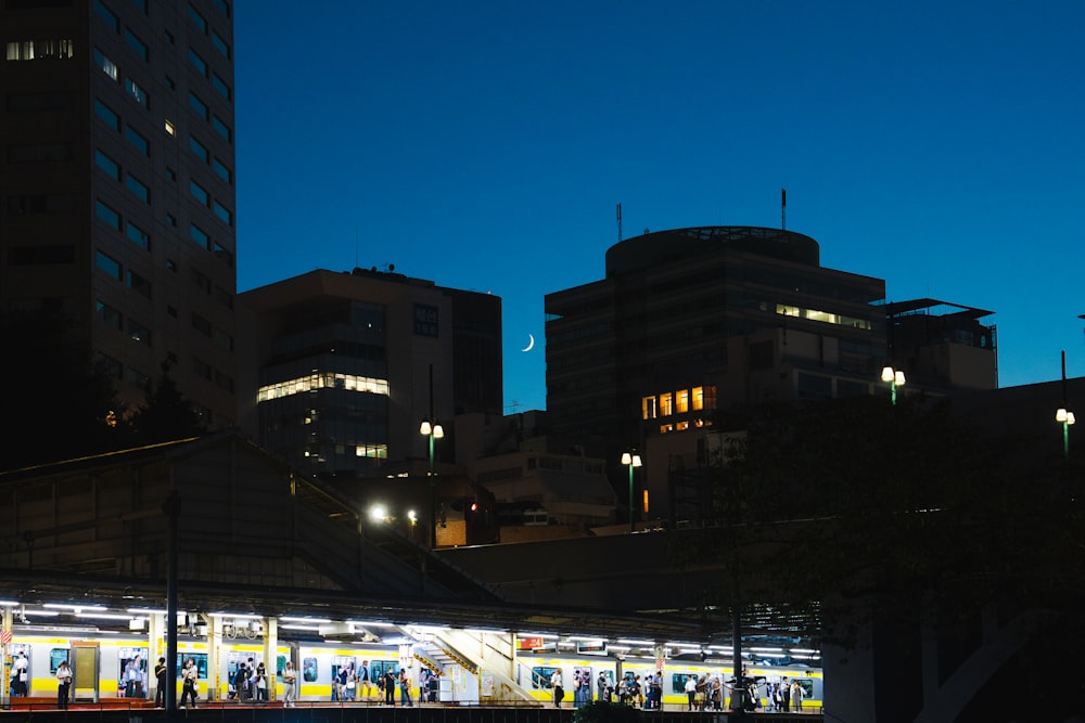 a train station in a city at night