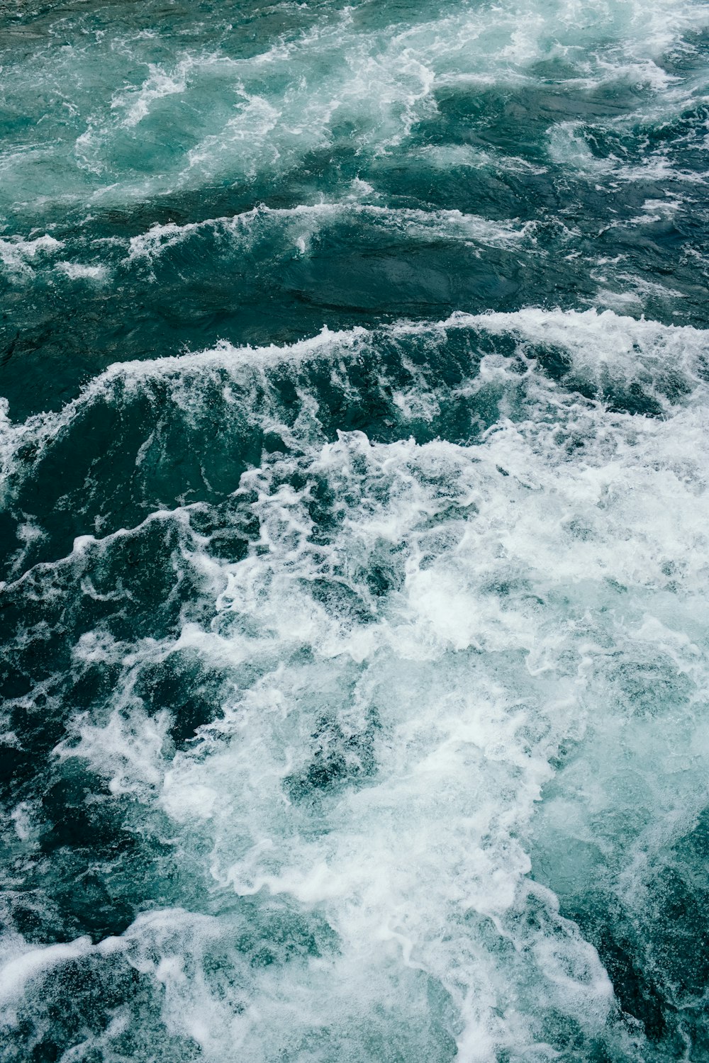 a large body of water with waves coming in and out of it