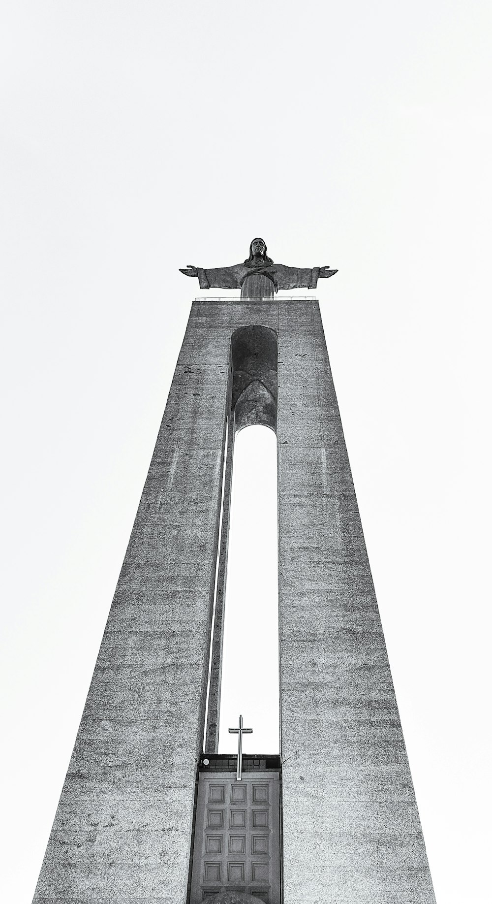 a tall tower with a cross on top of it