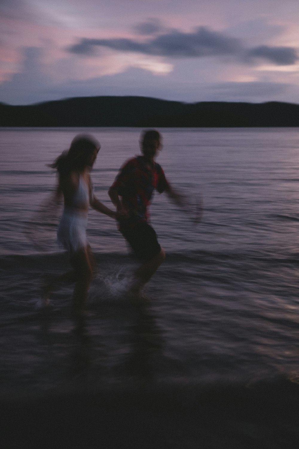 a couple of people that are standing in the water