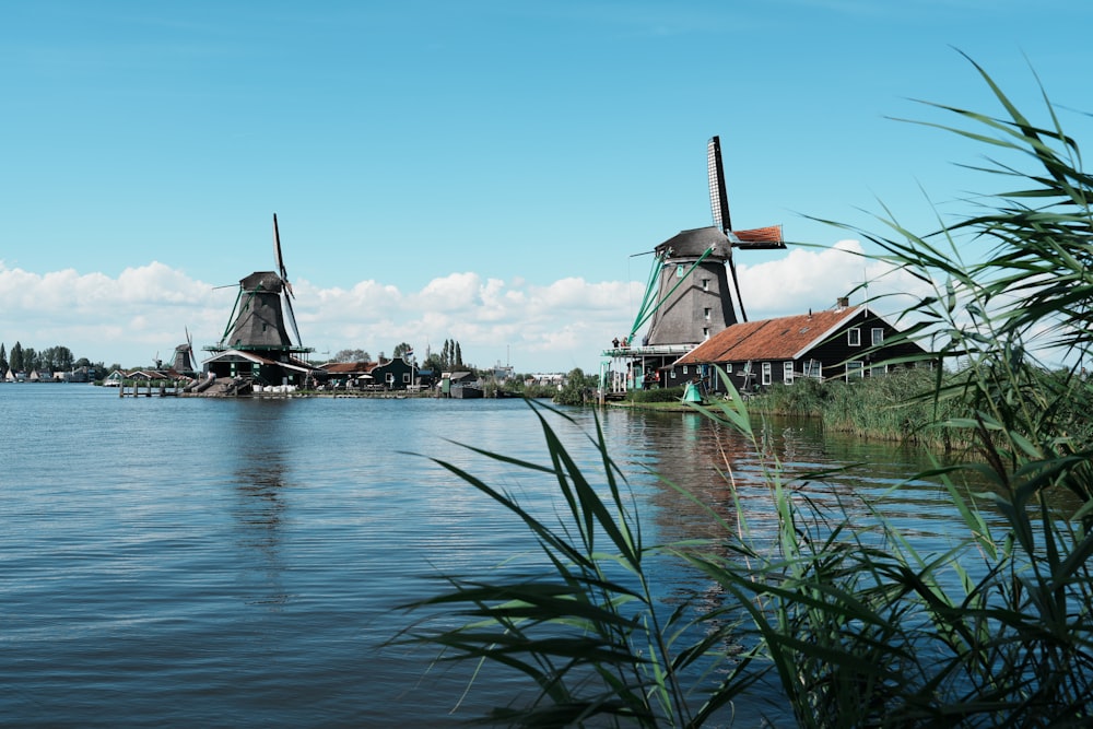 a couple of windmills sitting on top of a lake