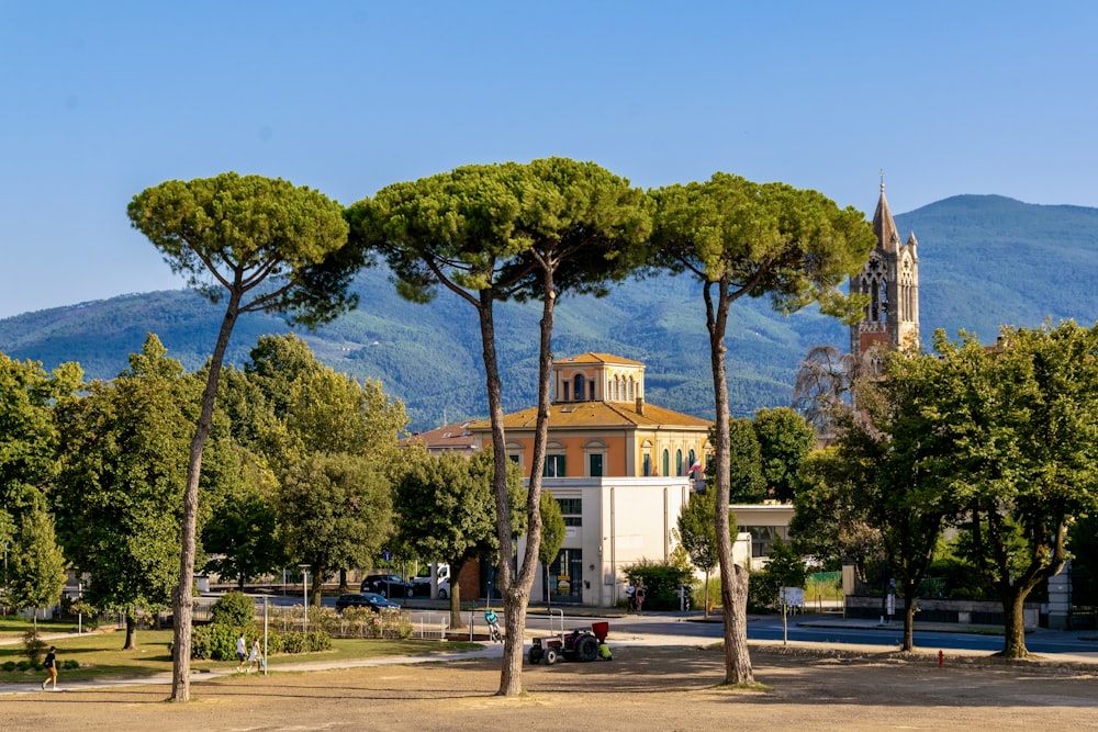 a building with a clock tower and trees in front of it