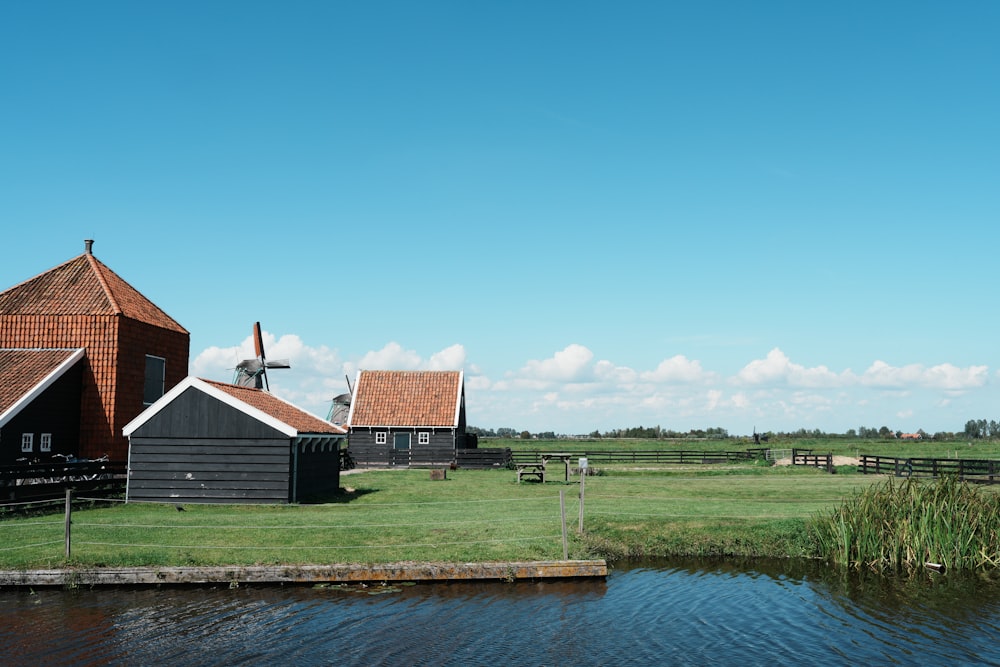 a farm with a windmill in the background