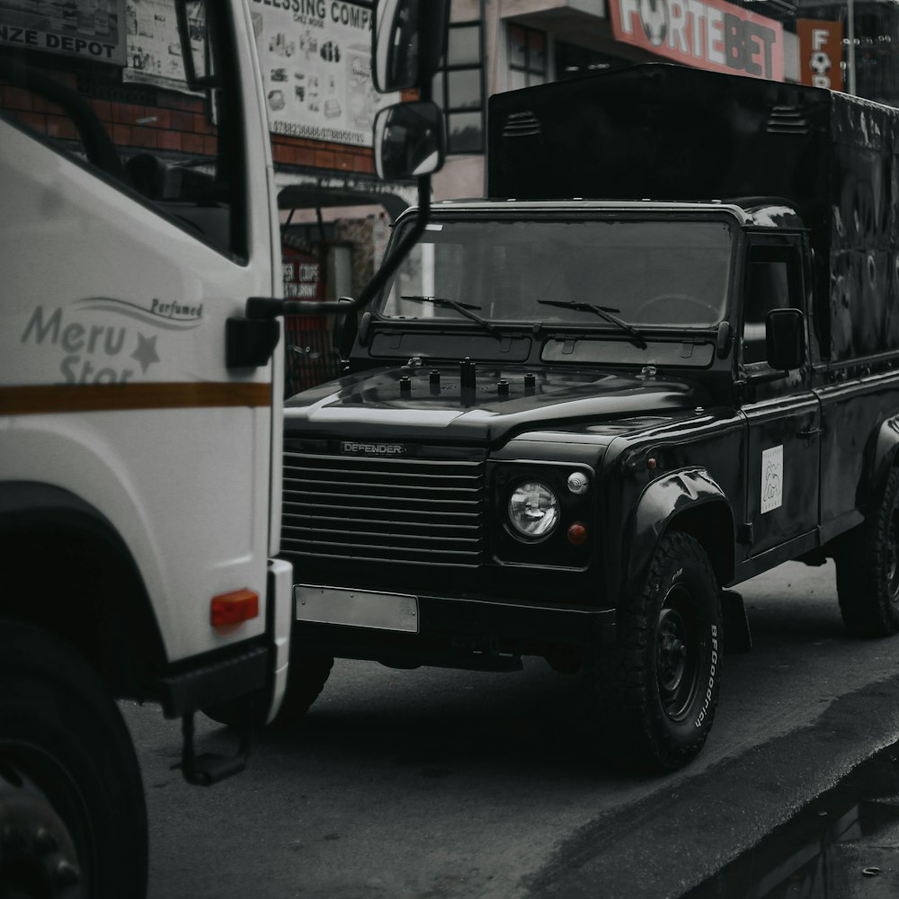 a black and white photo of a truck and a bus