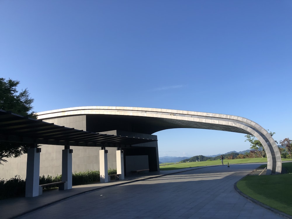 a curved walkway leading to a parking garage