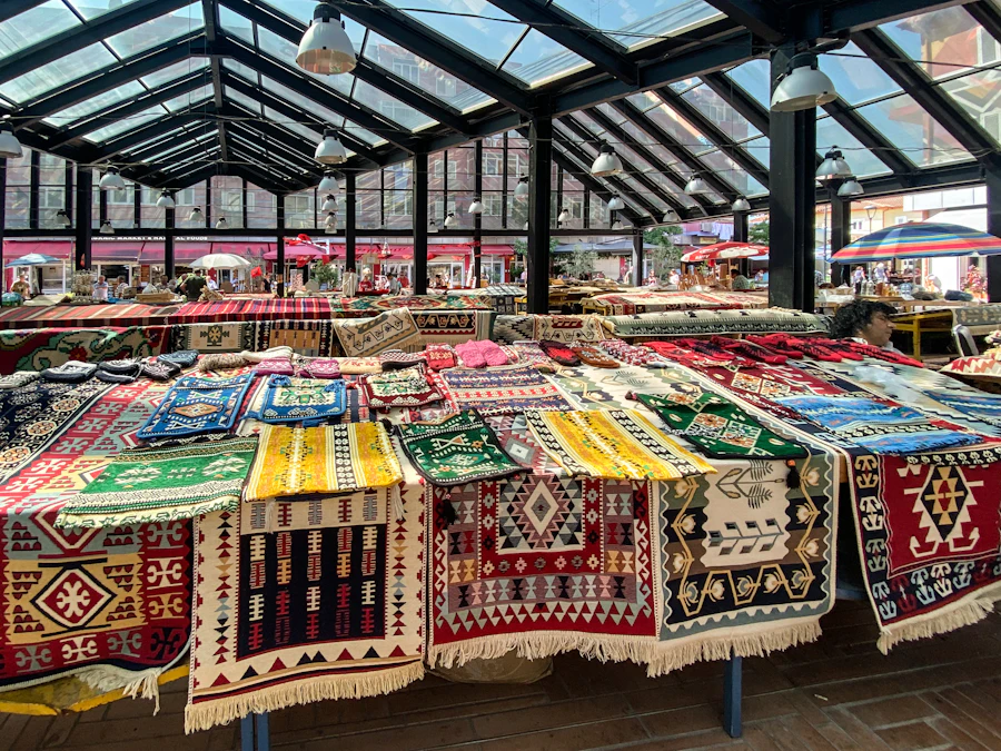 Colorful rugs displayed under the glass roof of Pazari i Ri in Tirana