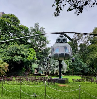 a helicopter statue in the middle of a park