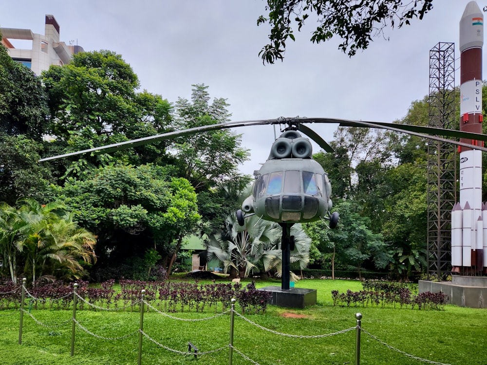 a helicopter statue in the middle of a park