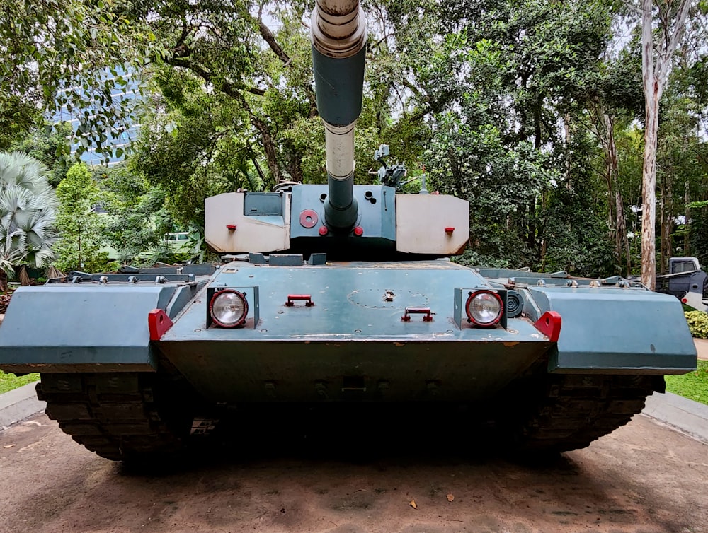 a military tank is parked in a park