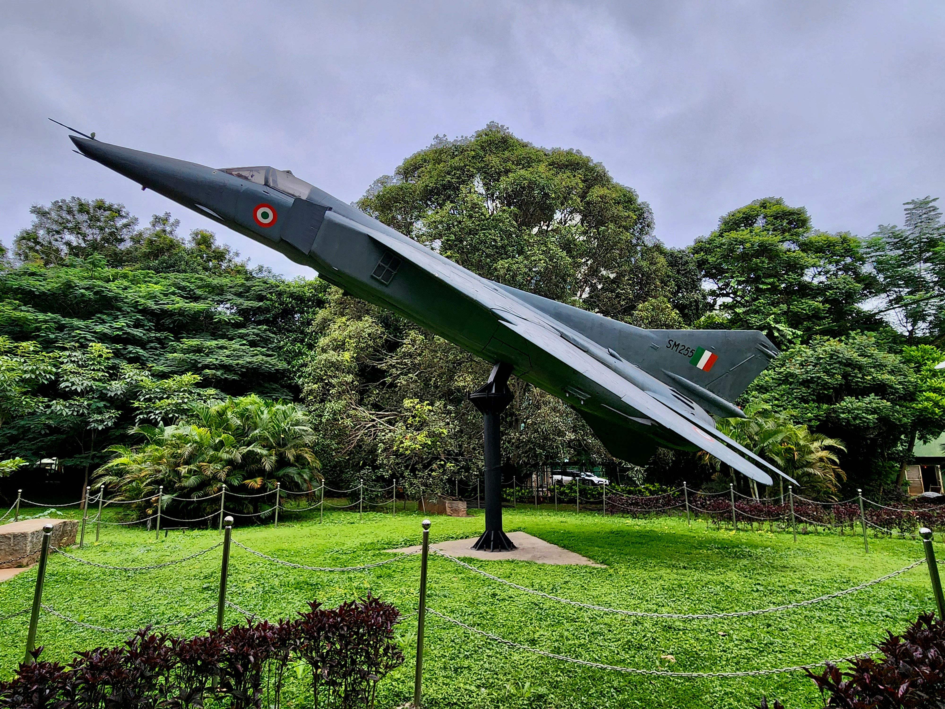 a fighter jet sitting on top of a lush green field, The Mikoyan-Gurevich MiG-23 is a variable-geometry fighter aircraft, designed by the Mikoyan-Gurevich design bureau in the Soviet Union. It is a third-generation jet fighter, that on 26 May, the Indian forces started using for air strikes during the Kargil War.