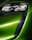 A close-up view of a modern car's front headlight assembly. The headlight features sleek, black detailing with reflective surfaces and is framed by a vibrant green body panel. The smooth curves and glossy finish highlight the vehicle's futuristic and polished design.