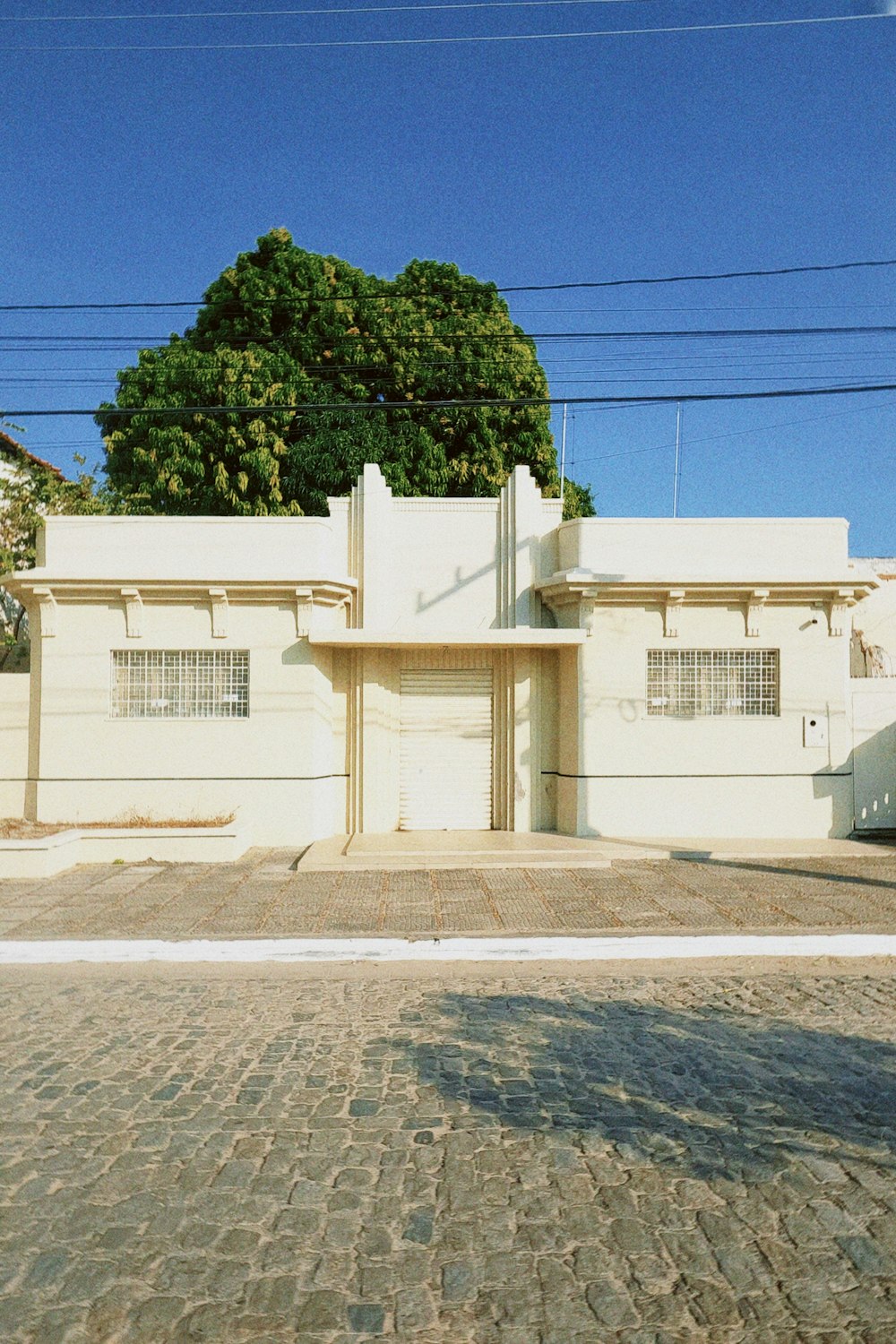 a white building sitting on the side of a road