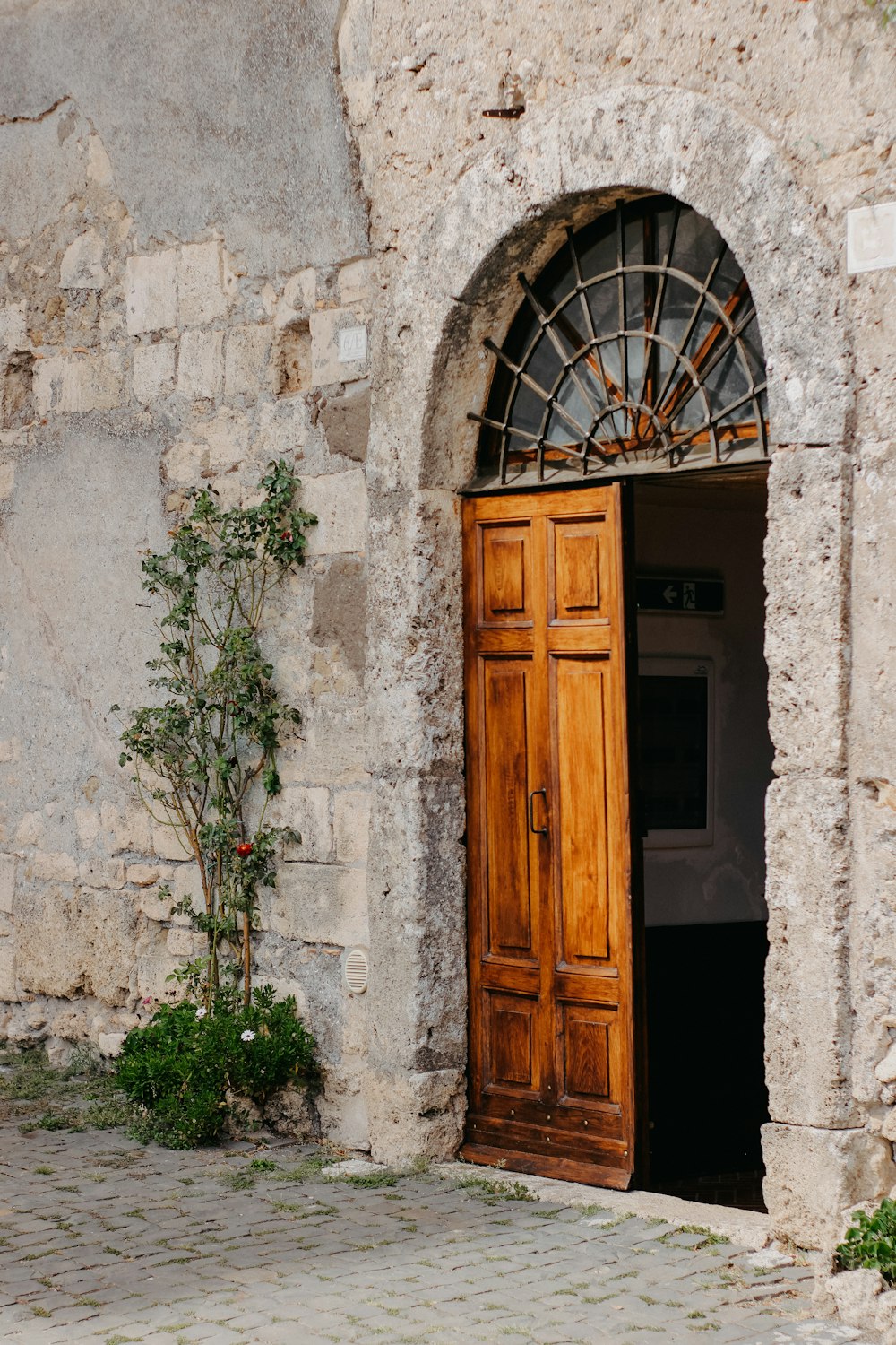 a wooden door with a window on a stone building