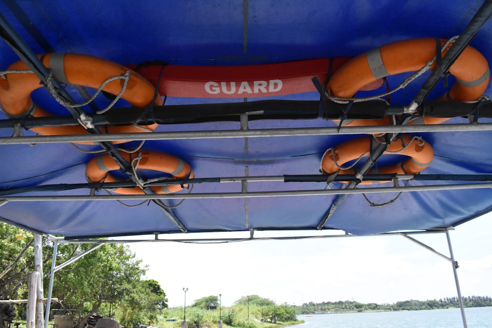 a blue and orange boat with life vests on it