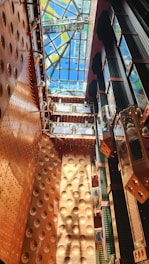 Close-up of a beautifully finished ceiling with textured wall and copper accent lighting in a modern interior.