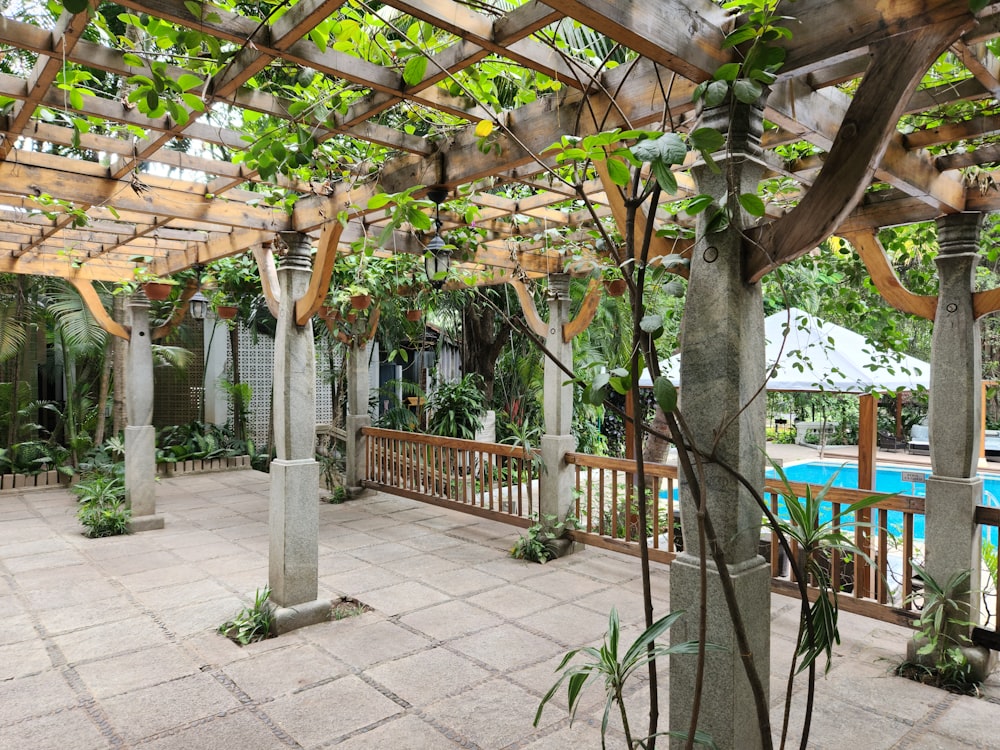 a patio with a pool in the background