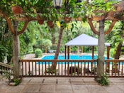 a gazebo with a pool in the background