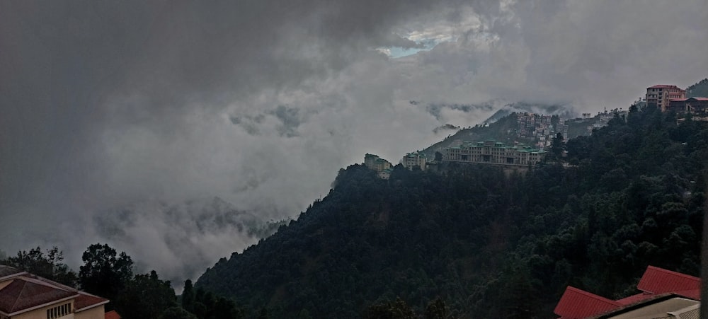 a view of a town on a mountain with a cloudy sky