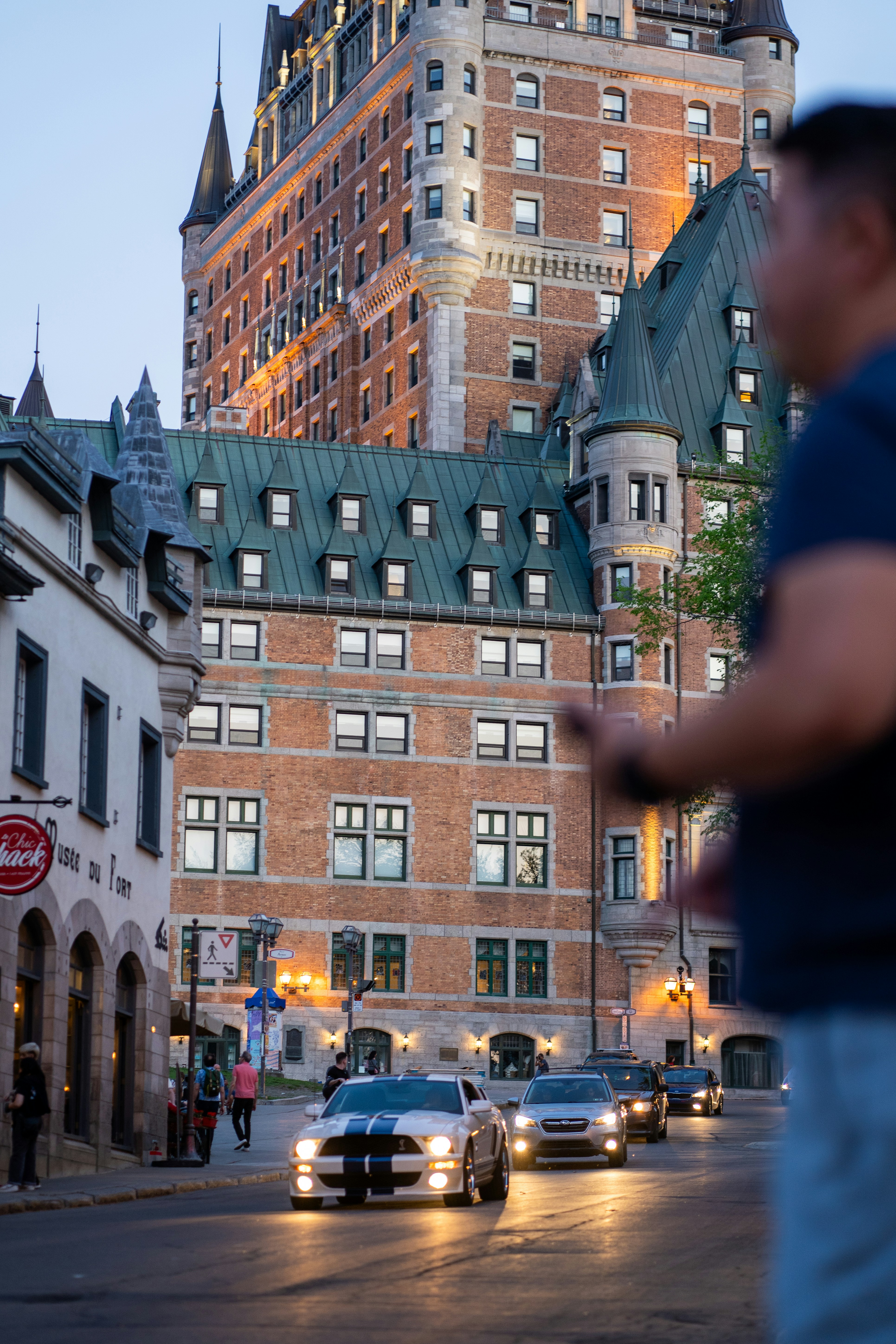 A man standing in front of a tall building photo – Free Québec Image on ...