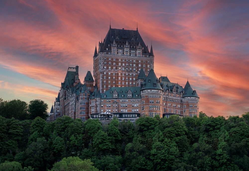 a large building with a tower on top of a hill