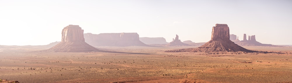 a desert landscape with mountains and rocks in the background