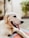 A joyful golden retriever resting comfortably inside a spacious pet cage outdoors.