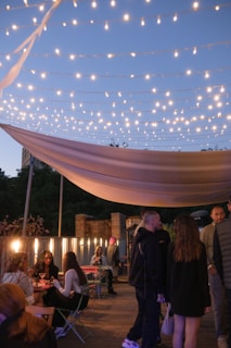 Guests enjoying a cozy evening gathering in the hotel’s garden courtyard with soft lighting.
