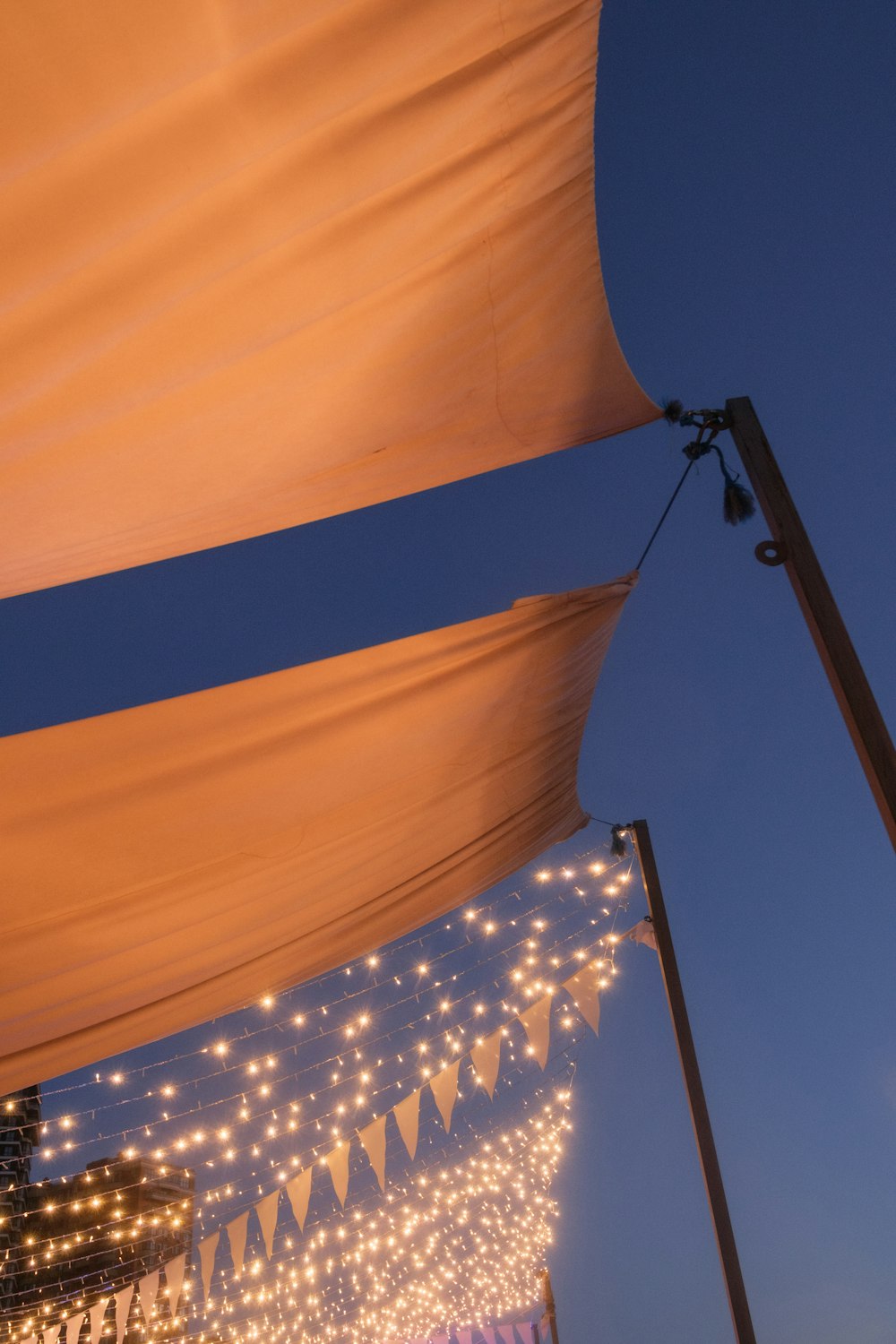 a large white tent with lights hanging from it's sides