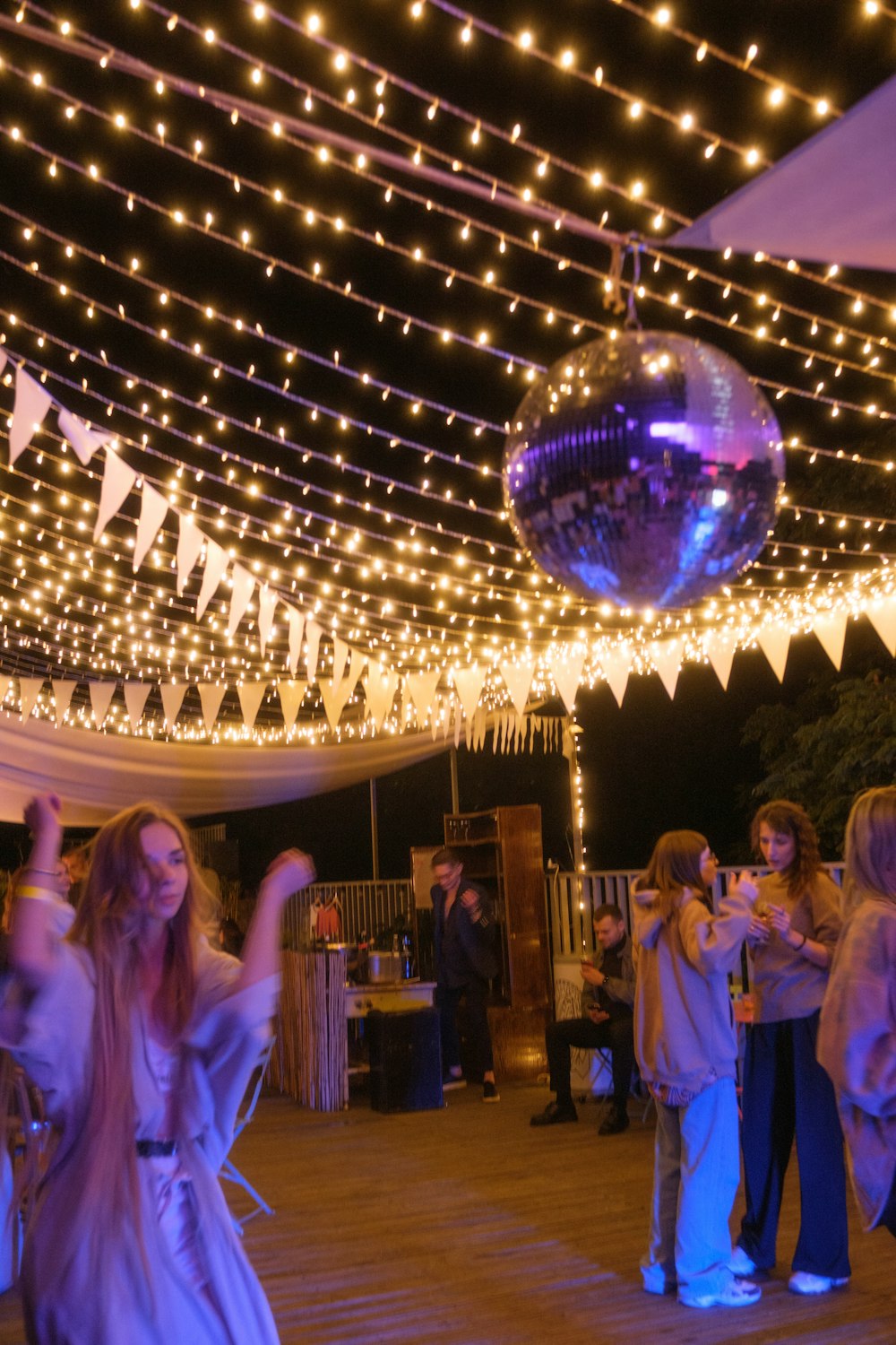 a group of people standing around a disco ball