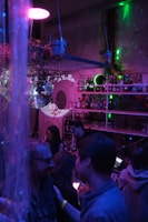 A vibrant scene of players enjoying drinks and solving clues under colorful disco lights.