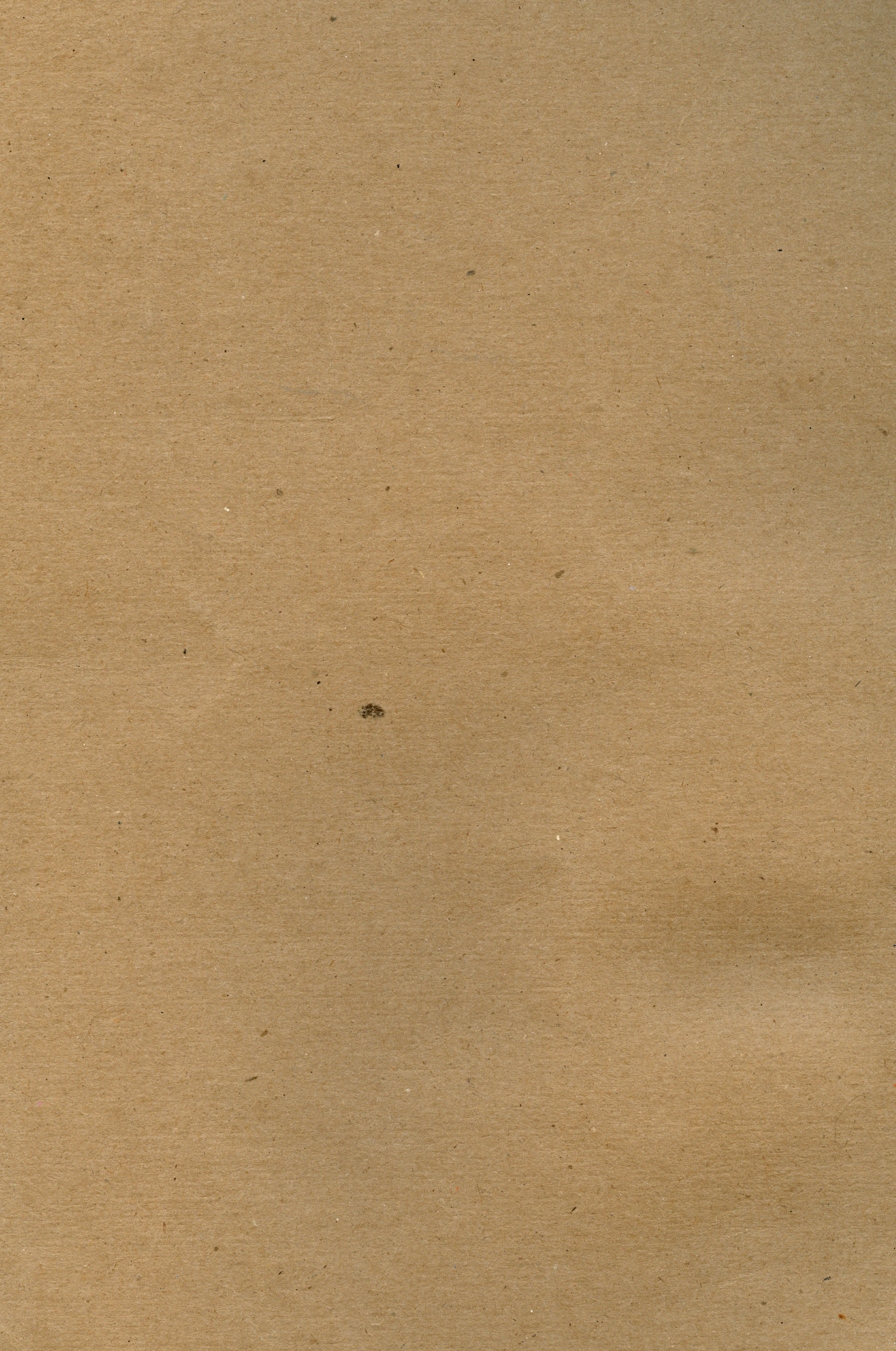 a piece of brown paper with a black dot on it