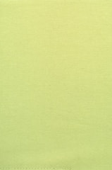 Green-toned adhesive being sprayed onto mattress fabric.