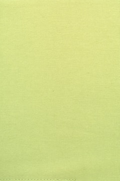 Green-toned adhesive being sprayed onto mattress fabric.