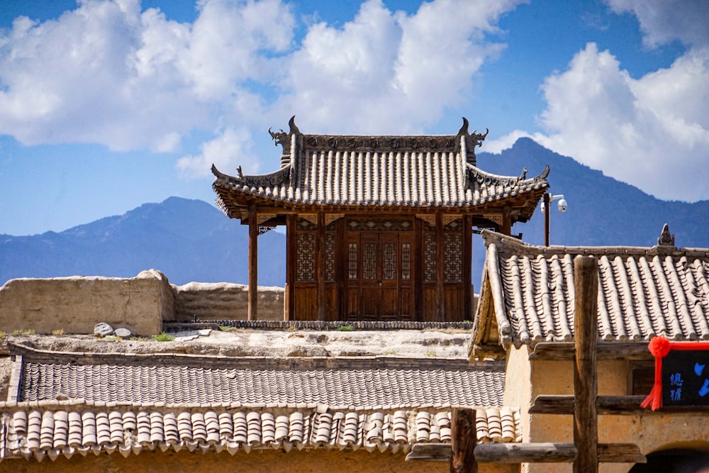 a chinese building with a mountain in the background