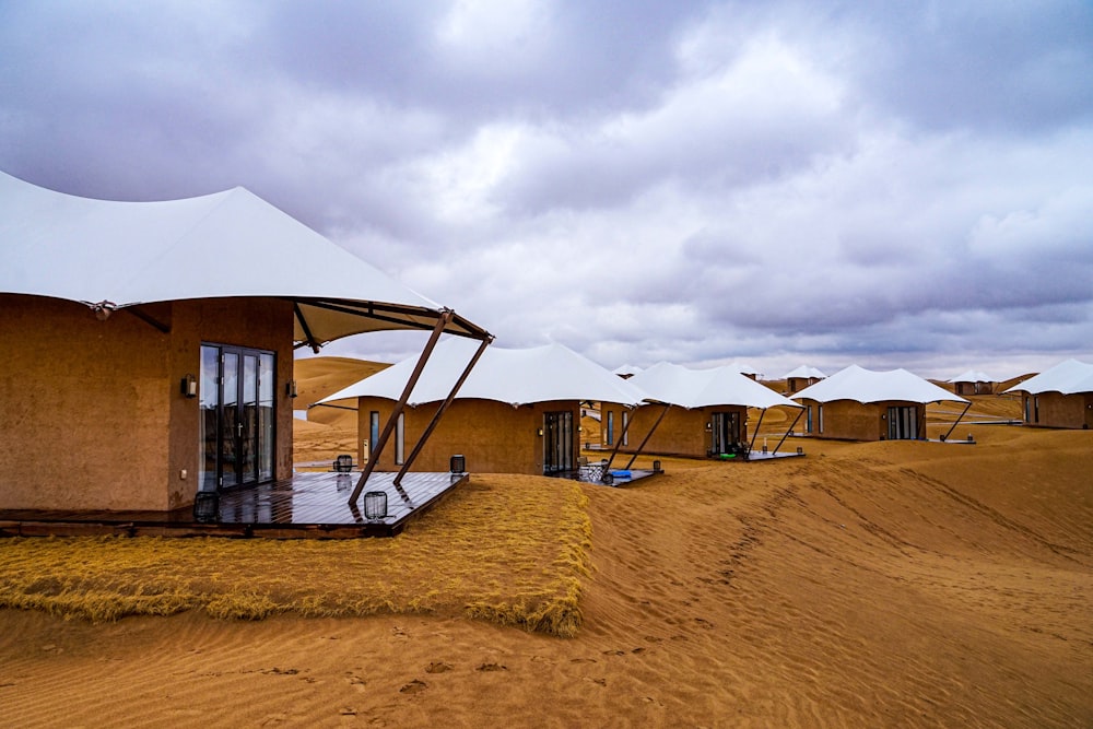 a group of tents sitting on top of a dirt field