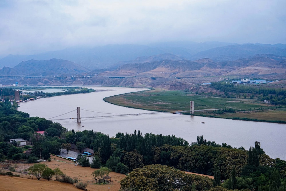 a view of a river and a bridge in the distance