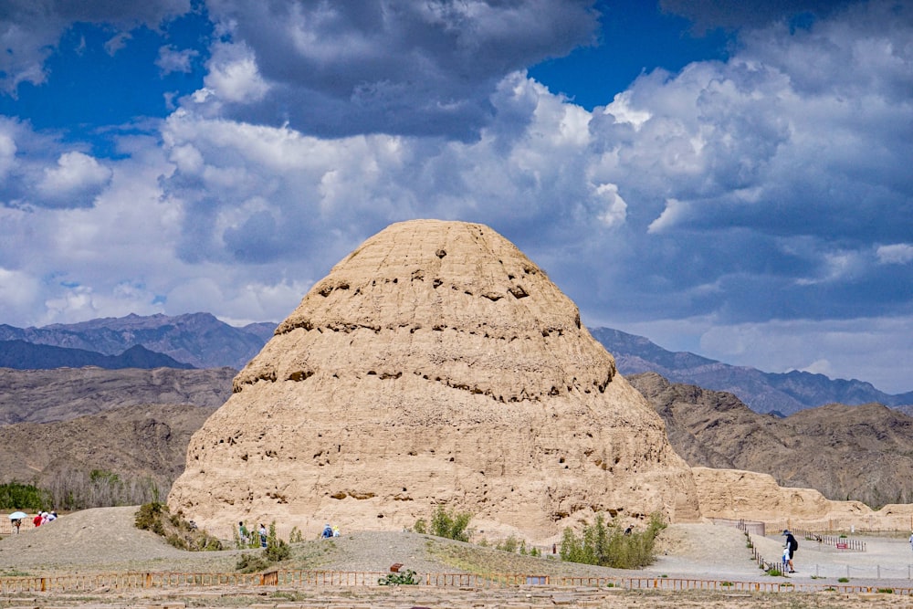 a large rock formation in the middle of a desert